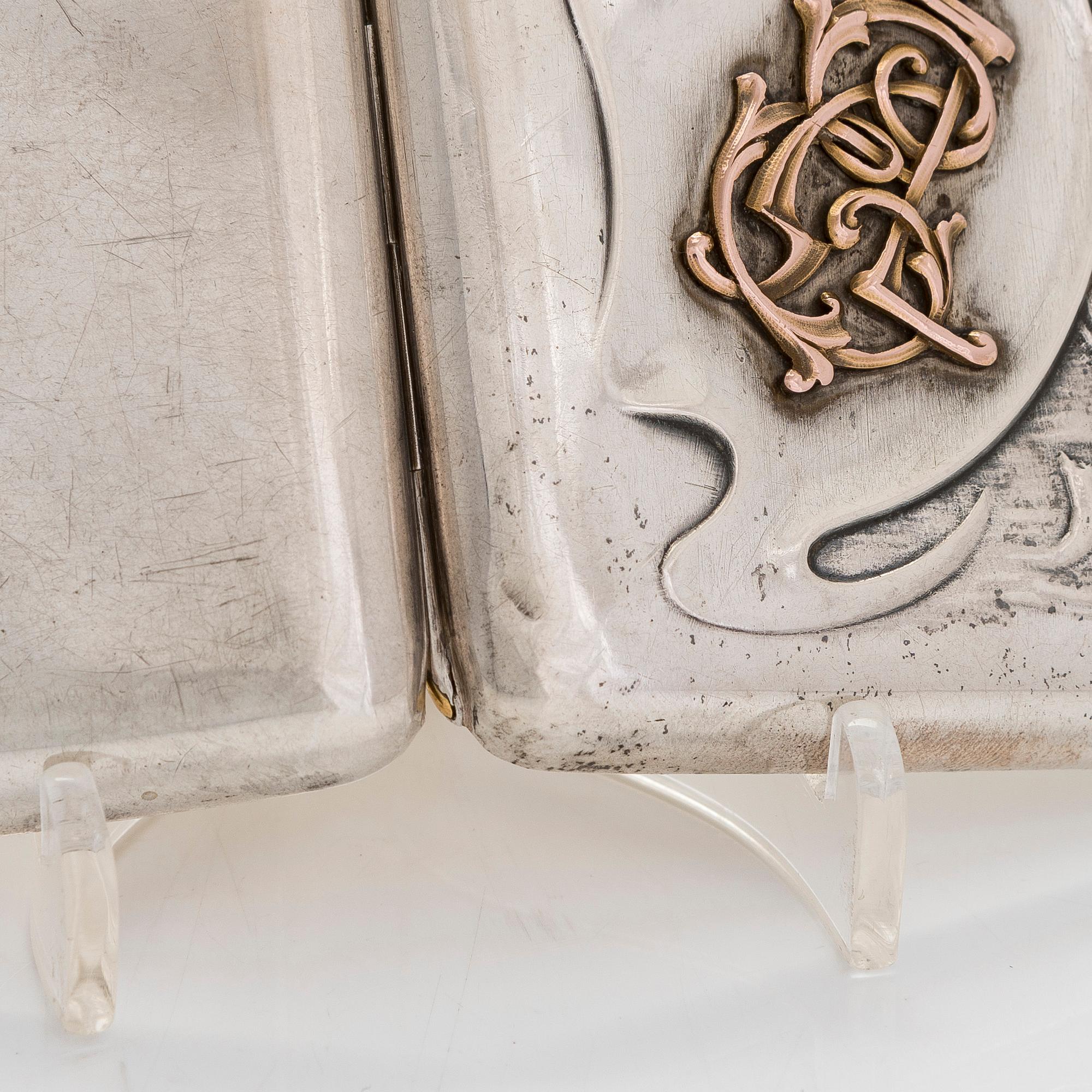 A silver cigarette case, Moscow, dated 1916.