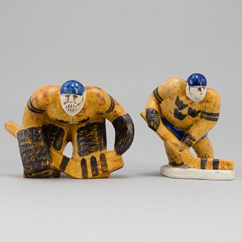 LISA LARSON, two stoneware figurines, "Ishockeyspelare", Gustavsberg. Designed in 1973.