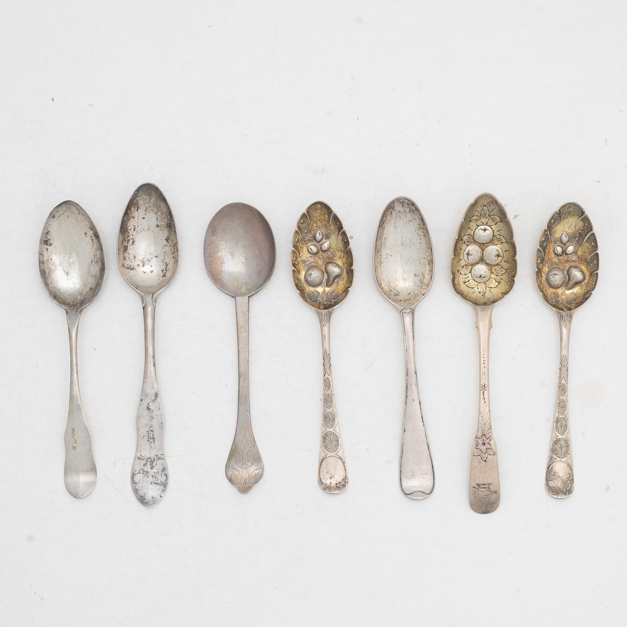 Seven silver spoons, including English and Swedish hallmarks.