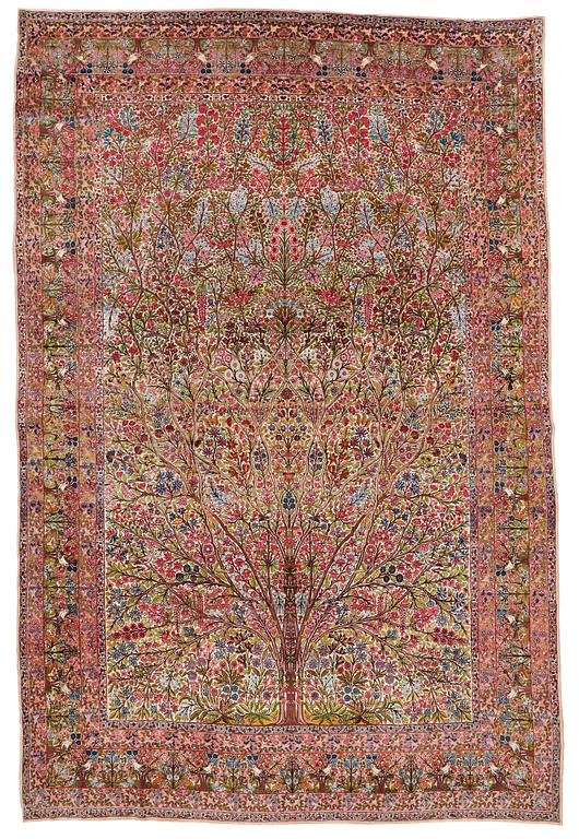 A CARPET, a semi-antique Kerman, ca 479 x 317 cm.