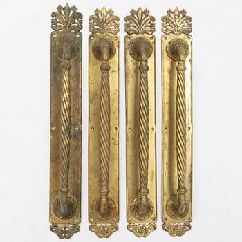 Four brass door handles, around 1900.