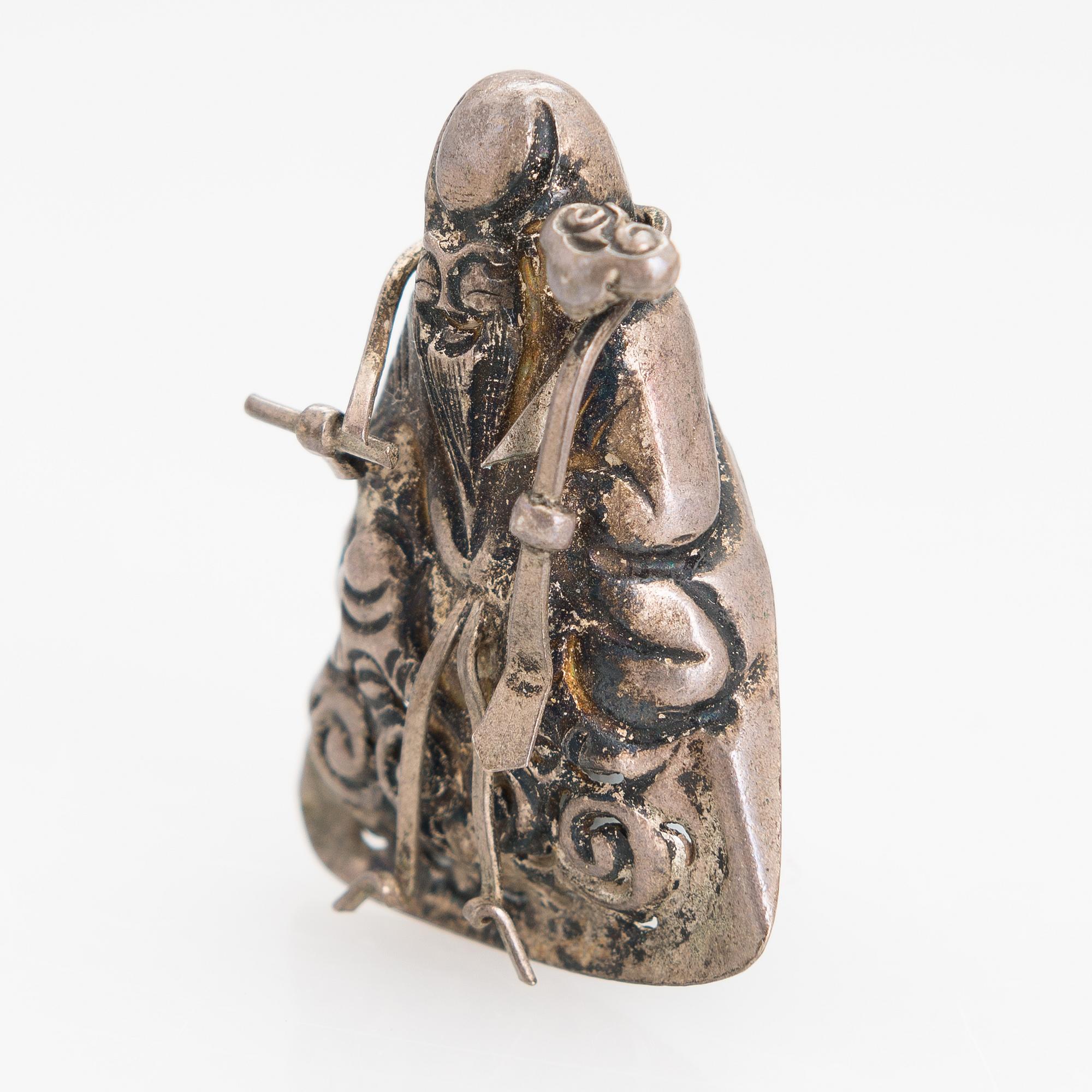 A silver figurine. China early 20th century.