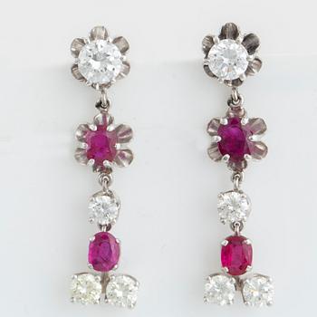 Oval faceted ruby and brilliant-cut diamond earrings.