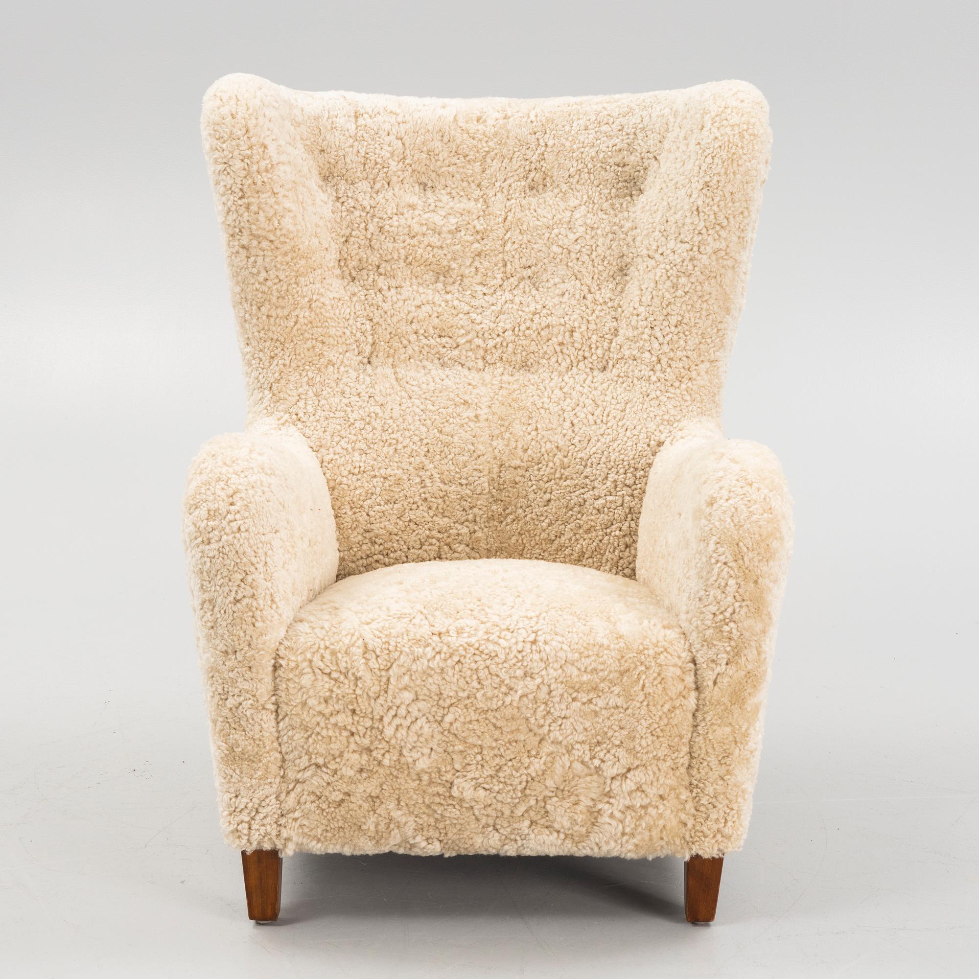 A variation of model 1672 new sheepskin upholstered lounge chair from Fritz Hansen.