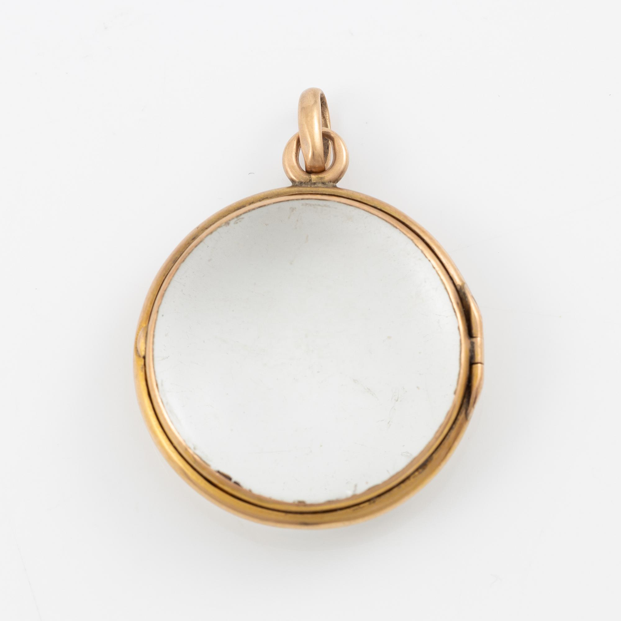 Medaljong, guld och glas.