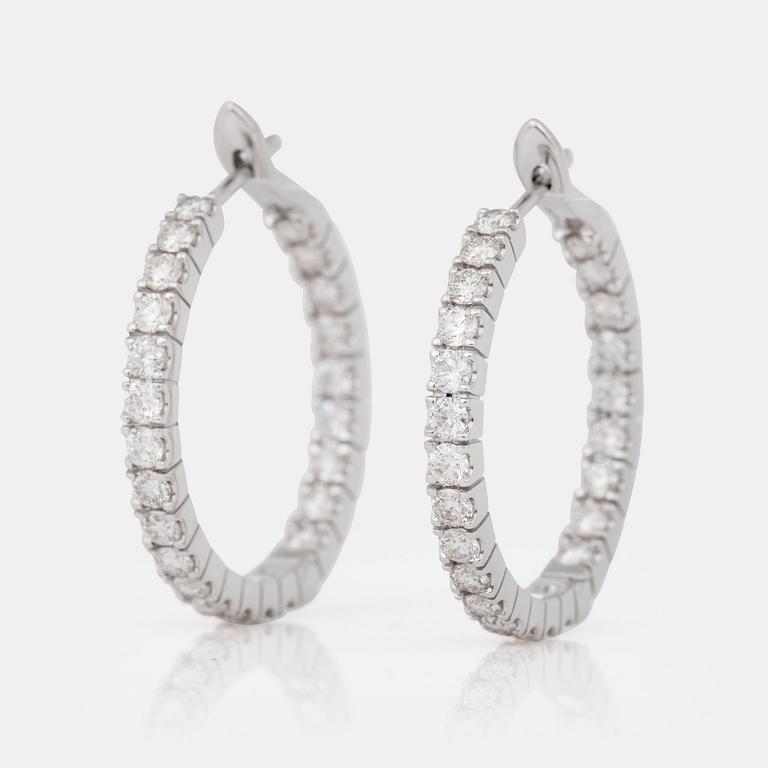 A pair of diamond, 2.303 cts according to engraving, loop earrings.