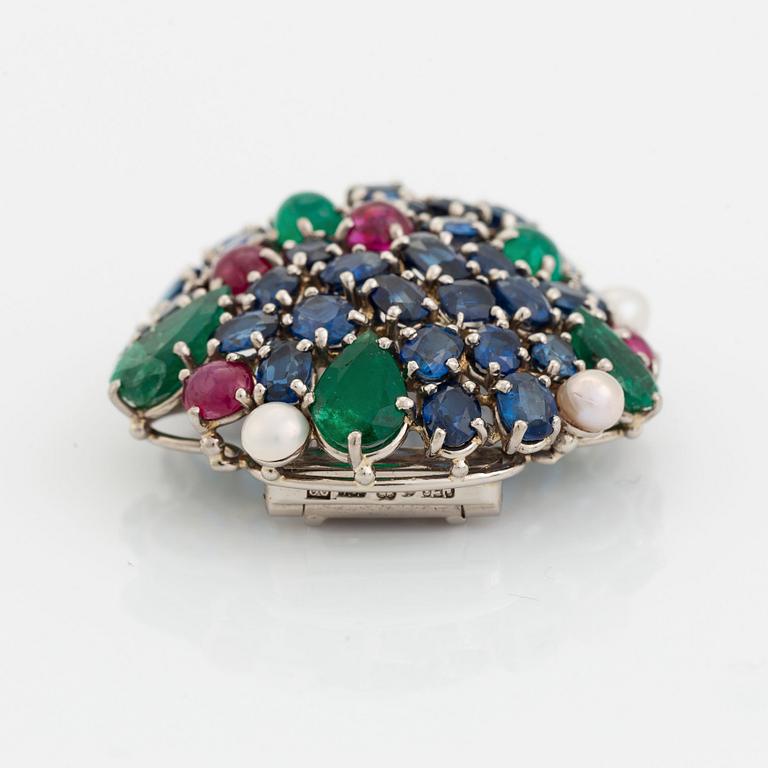 An 18K gold Carlman brooch set with sapphires, emeralds, rubies and pearls.