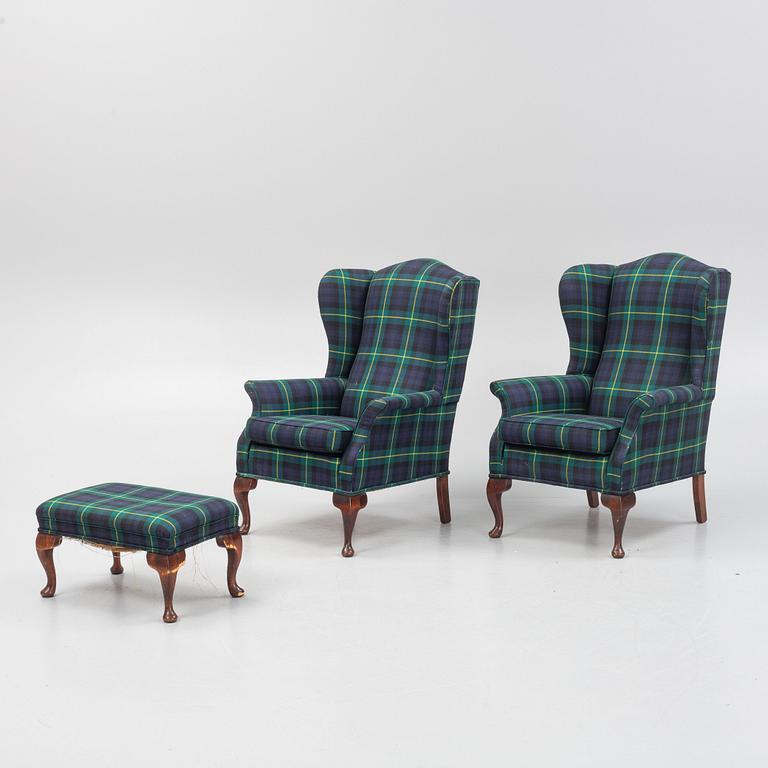 A pair of wingback armchairs and a footstool, England, second half of the 20th century.