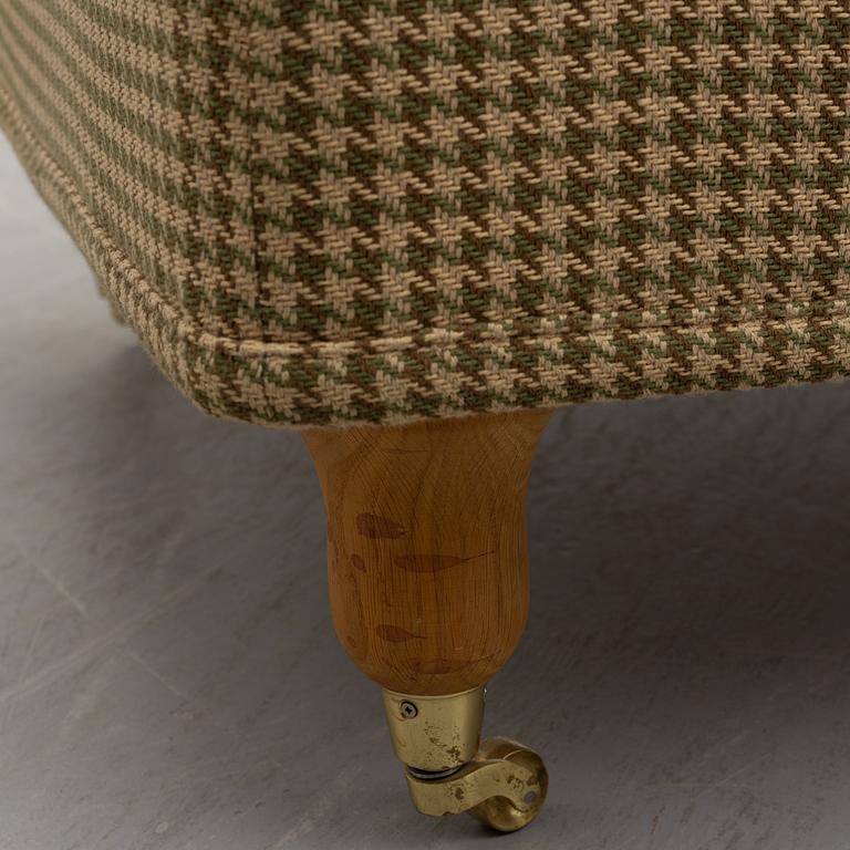 A foot stool by Fogia dressed in Ralph Lauren fabric.