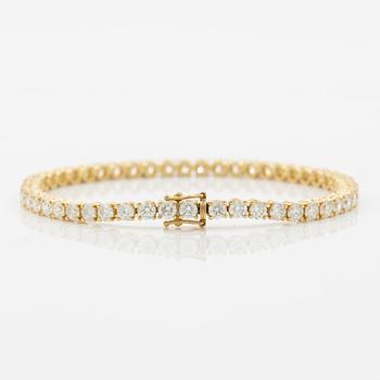 Tennis bracelet in 18K gold with round brilliant-cut diamonds.
