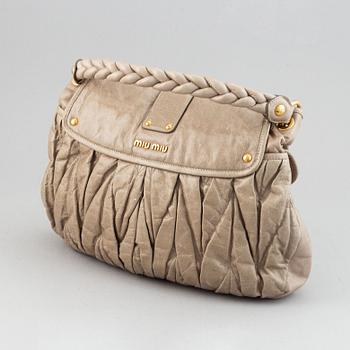 Miu Miu, a light leather handbag.