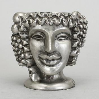 VAS, tenn, "Janushuvud", formgiven av Anna Petrus, Firma Svenskt Tenn, Stockholm, 1957.