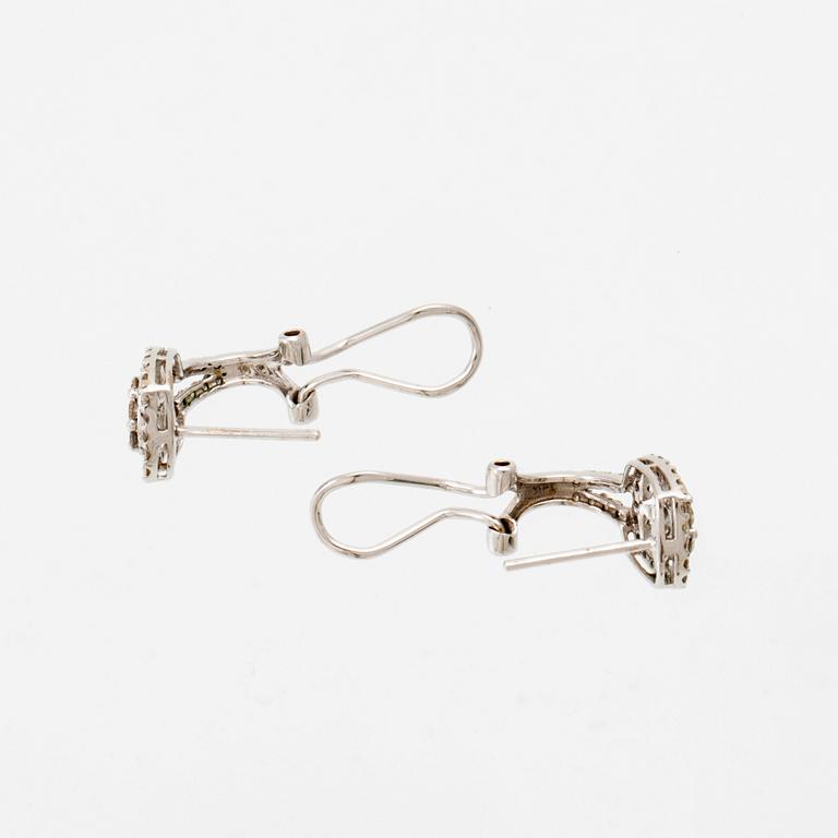 A pair of 14K white gold earrings set with round brilliant-cut diamonds.