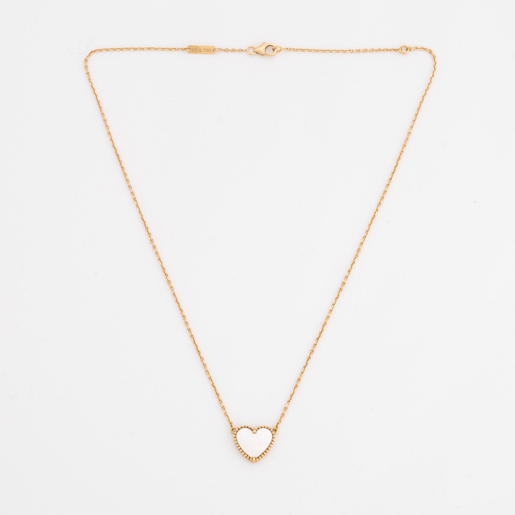 Van Cleef & Arpels, 18K gold and mother of pearl Alhambra heart necklace.