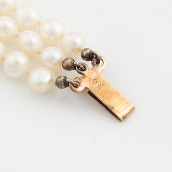 Bracelet, three-stranded with cultured pearls, clasp with a pearl and small diamonds.