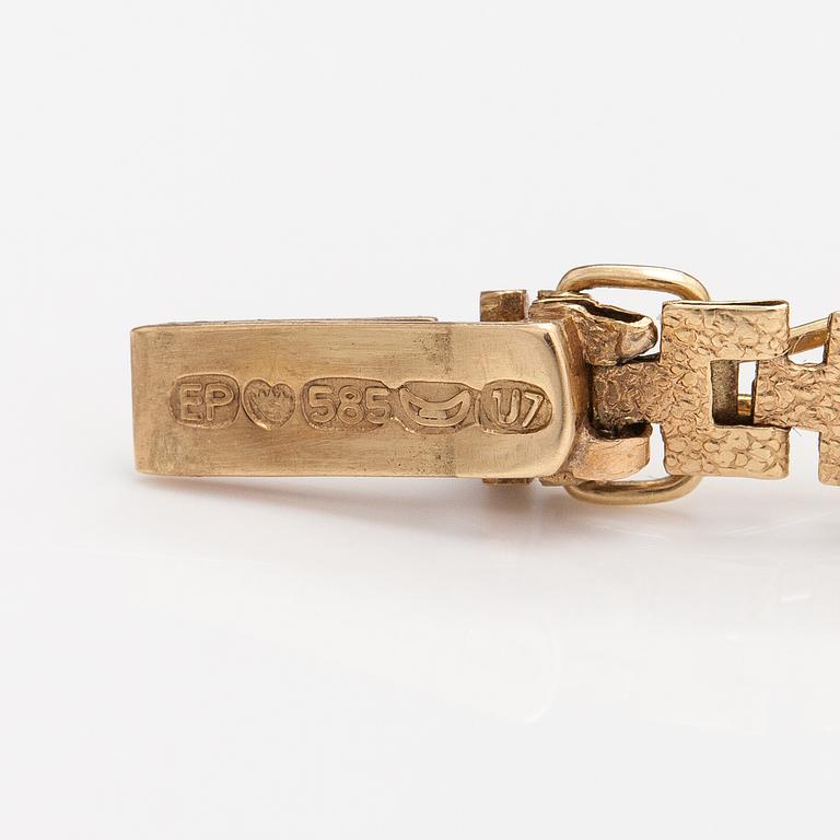 Rannekoru, 14K kultaa. Keravan Kultaseppä, Helsinki 1973.