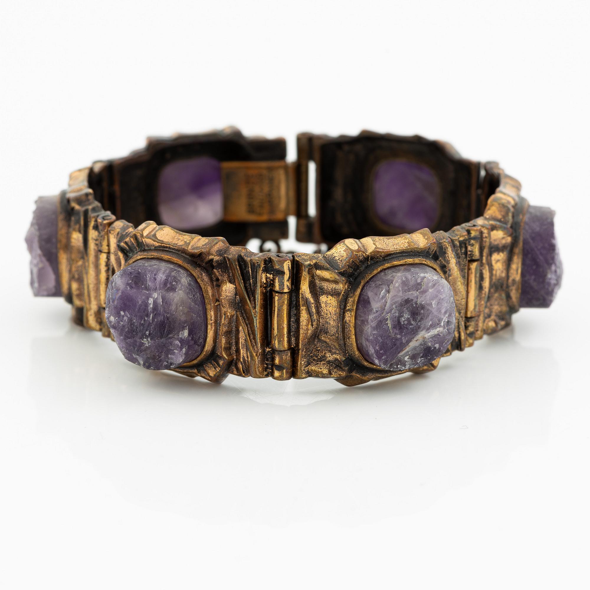 Pentti Sarpaneva, A bracelet, a pair of earrings, a ring, and a pendant, bronze with amethyst, Finland 1960s.