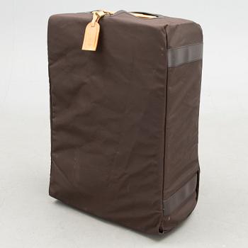 A Monogram Canvas Pégase 65 Suitcase with a Protective Cover.