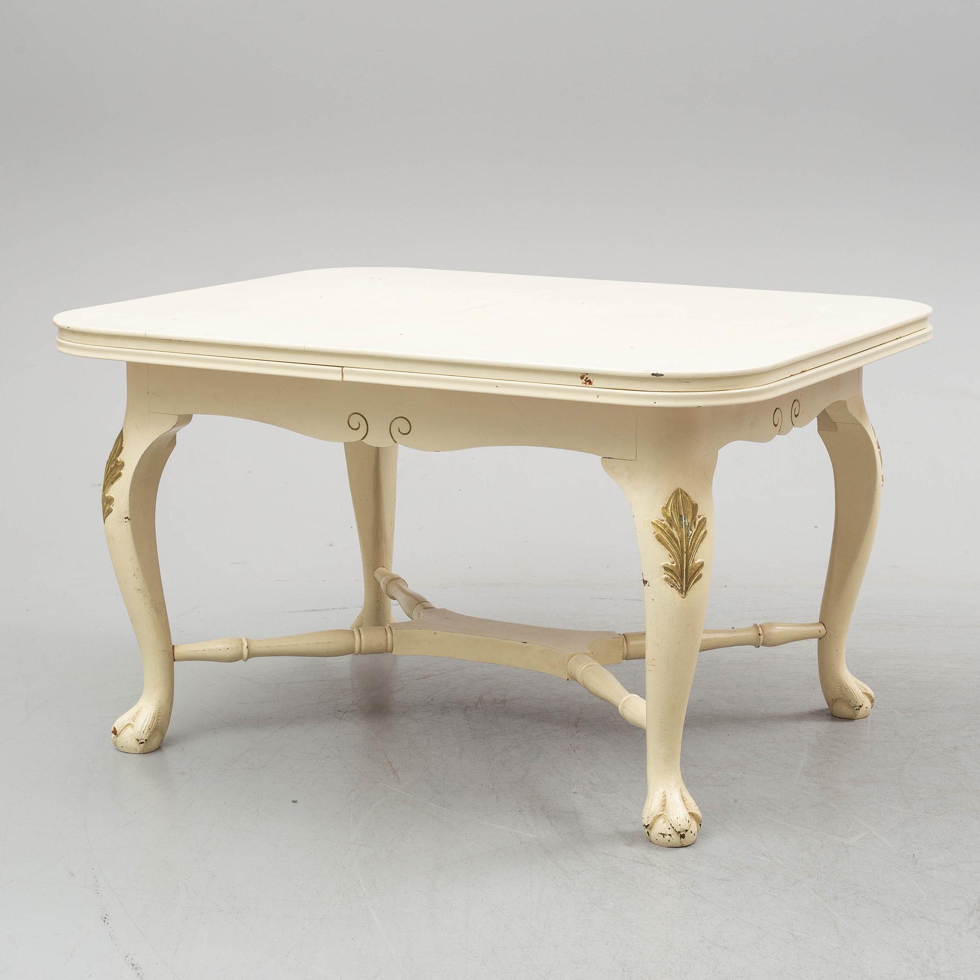 A dining table and six chairs, rococo style, mid 20th century.