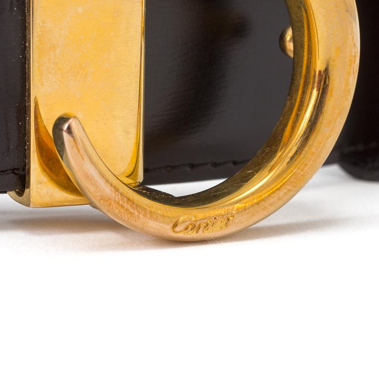 A black leather belt by Cartier.