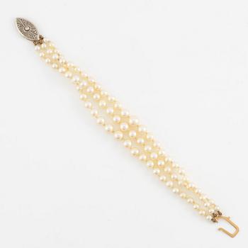 Bracelet, three-stranded with graduated cultured pearls, clasp 18K gold set with octagonal-cut diamonds.