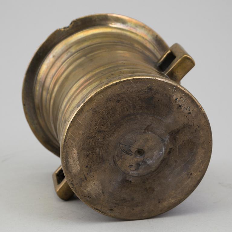 A 18th century brass mortar with pestle.