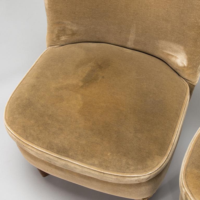 A pair of 1950s armchairs.