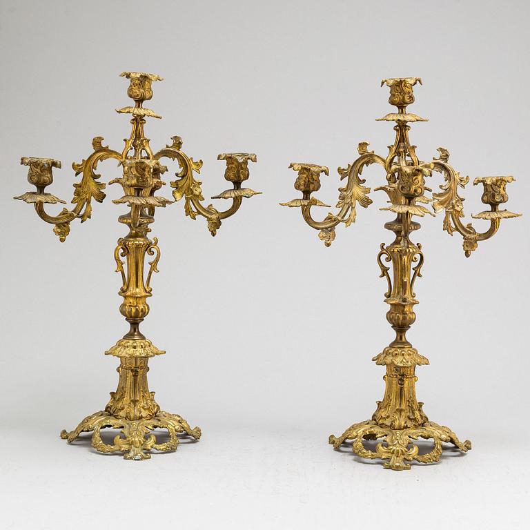 A pair of metal candelabra, late 19th Century.