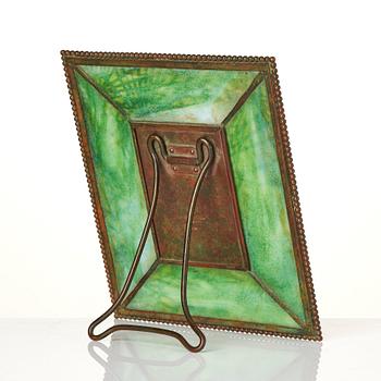 Louis Comfort Tiffany / Tiffany Studios, an Art Nouveau bronze and marbled "Pine needles" glass frame model "948", New York.