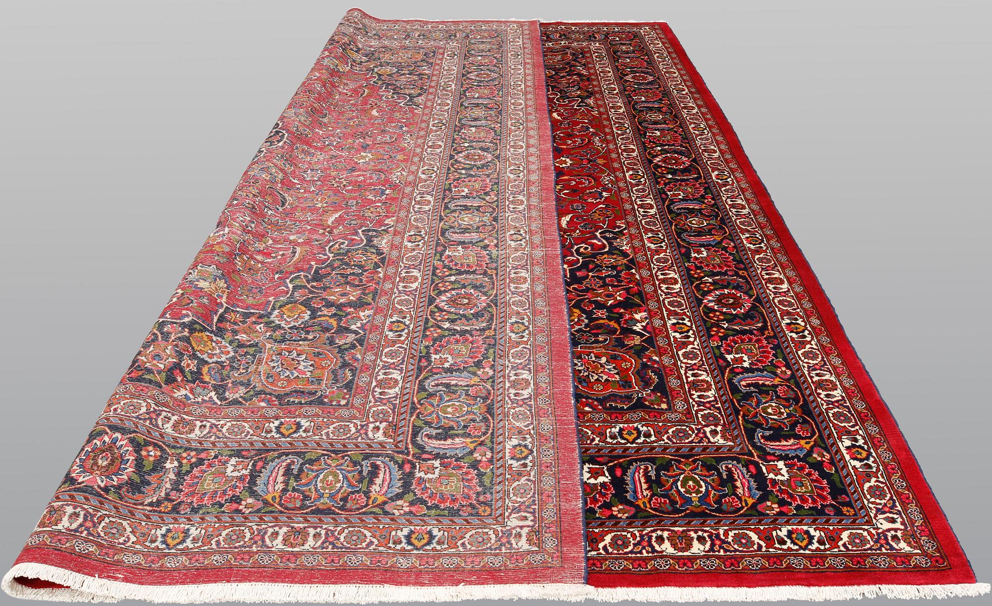A signed Mashad carpet, ca 375 x 303 cm.