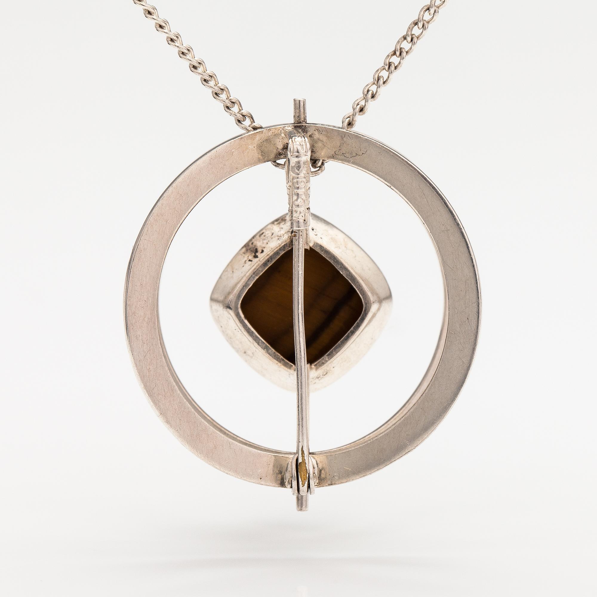 Elis Kauppi, A silver necklace/brooch with a tiger's eye. Kupittaan kulta, turku 1961.