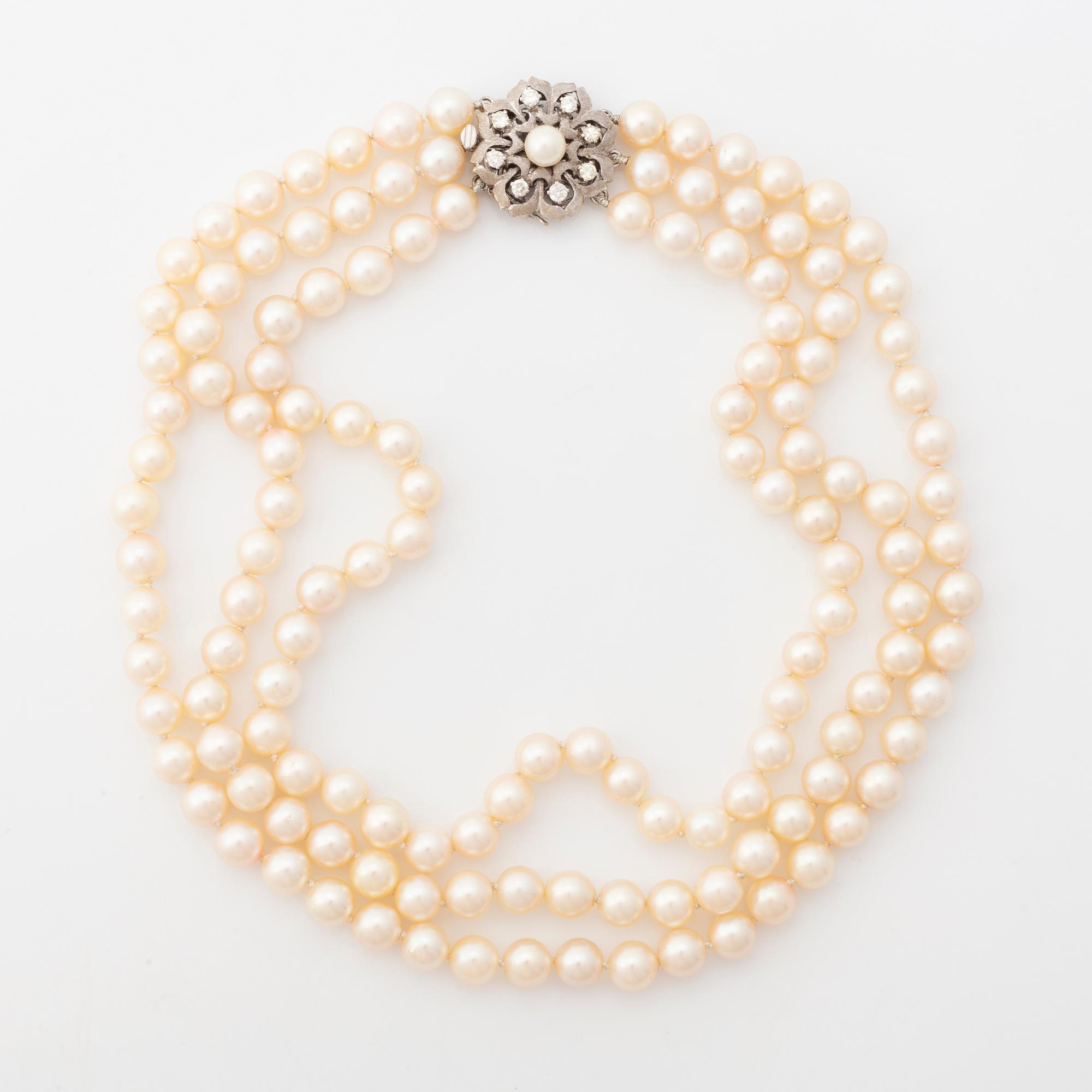 A three strand cultured pearl necklace.