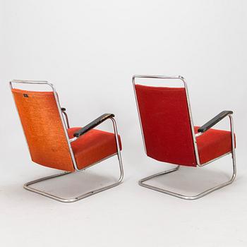 A pair of 1930s armchairs.