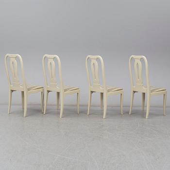 A Carl Malmsten dining table and four chairs. Three leaves included.