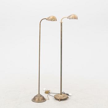 A set of two brass floor lamps later part of the 20th century.