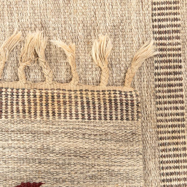 A Swedish flat weave carpet signed SH ca 243 x 162 cm.