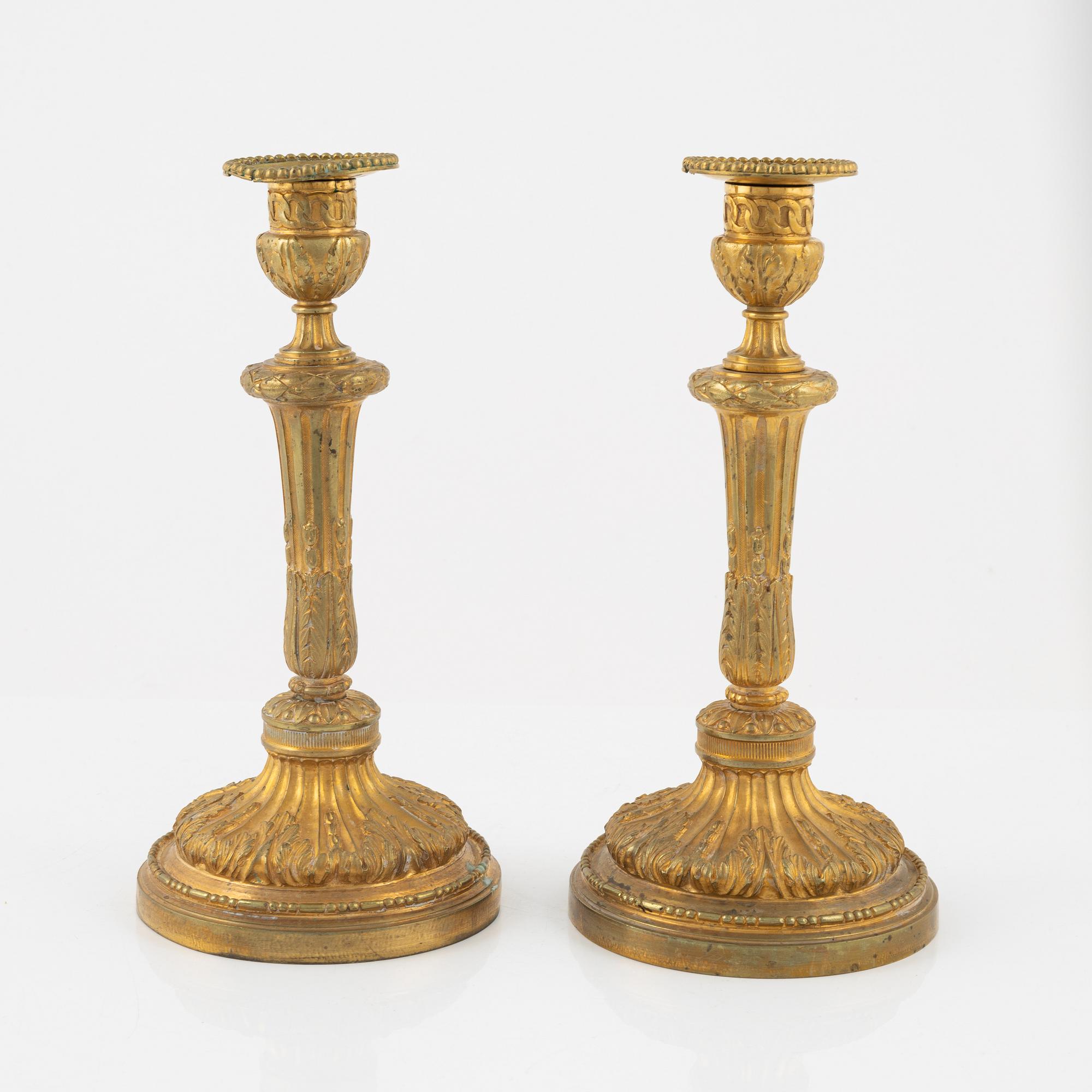 A pair of bronze candle sticks, 20th Century.