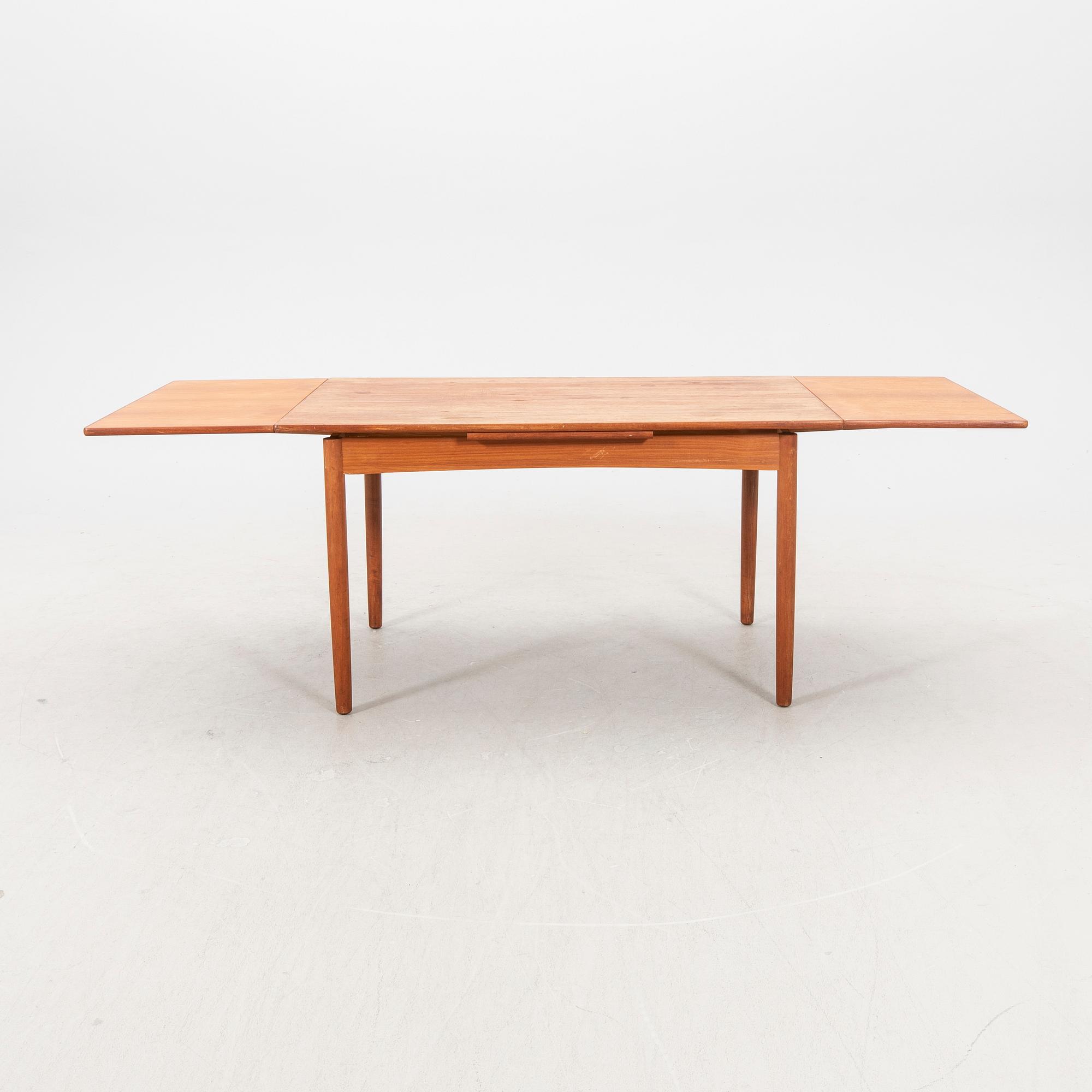 A 1960s teak dining table.