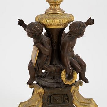 A pair of patinated bronze and ormolu neo-renaissance six-light candelabra, later part of the 19th Century.