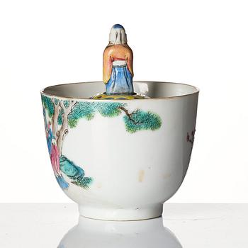 A famille rose 'trick cup' with a little figure, Qing dynasty, 19th Century.