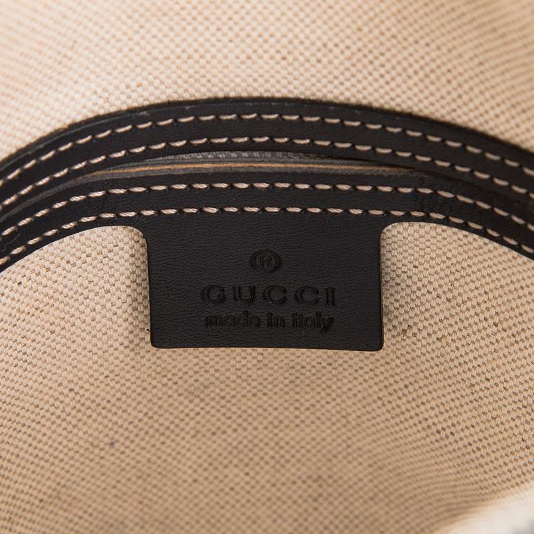 Gucci, A "GG Supreme messenger" bag.