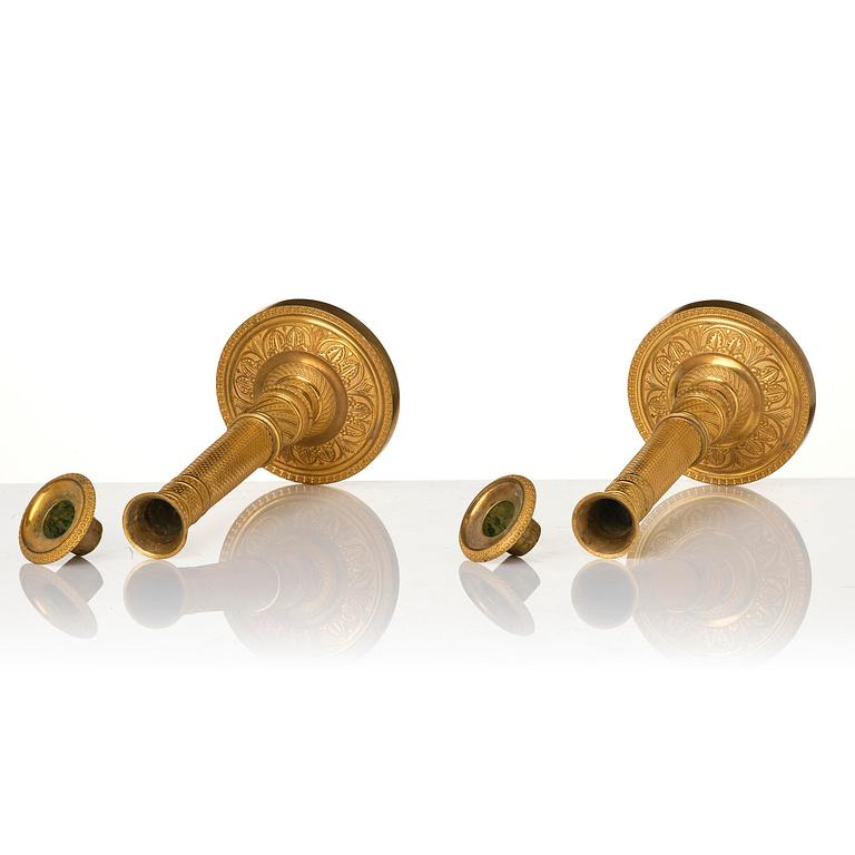 A pair of French Empire ormolu candlesticks, early 19th century.