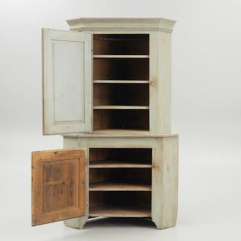 A 19th century corner cabinet.