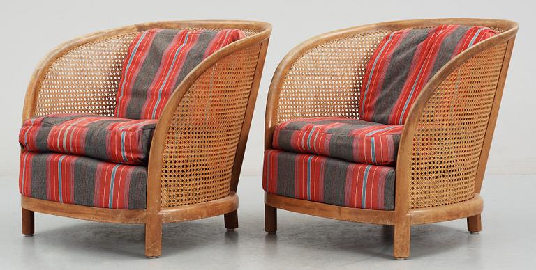 A pair of Oscar Nilsson beech and rattan arm chairs.