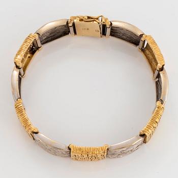An 18K gold and white gold bracelet.