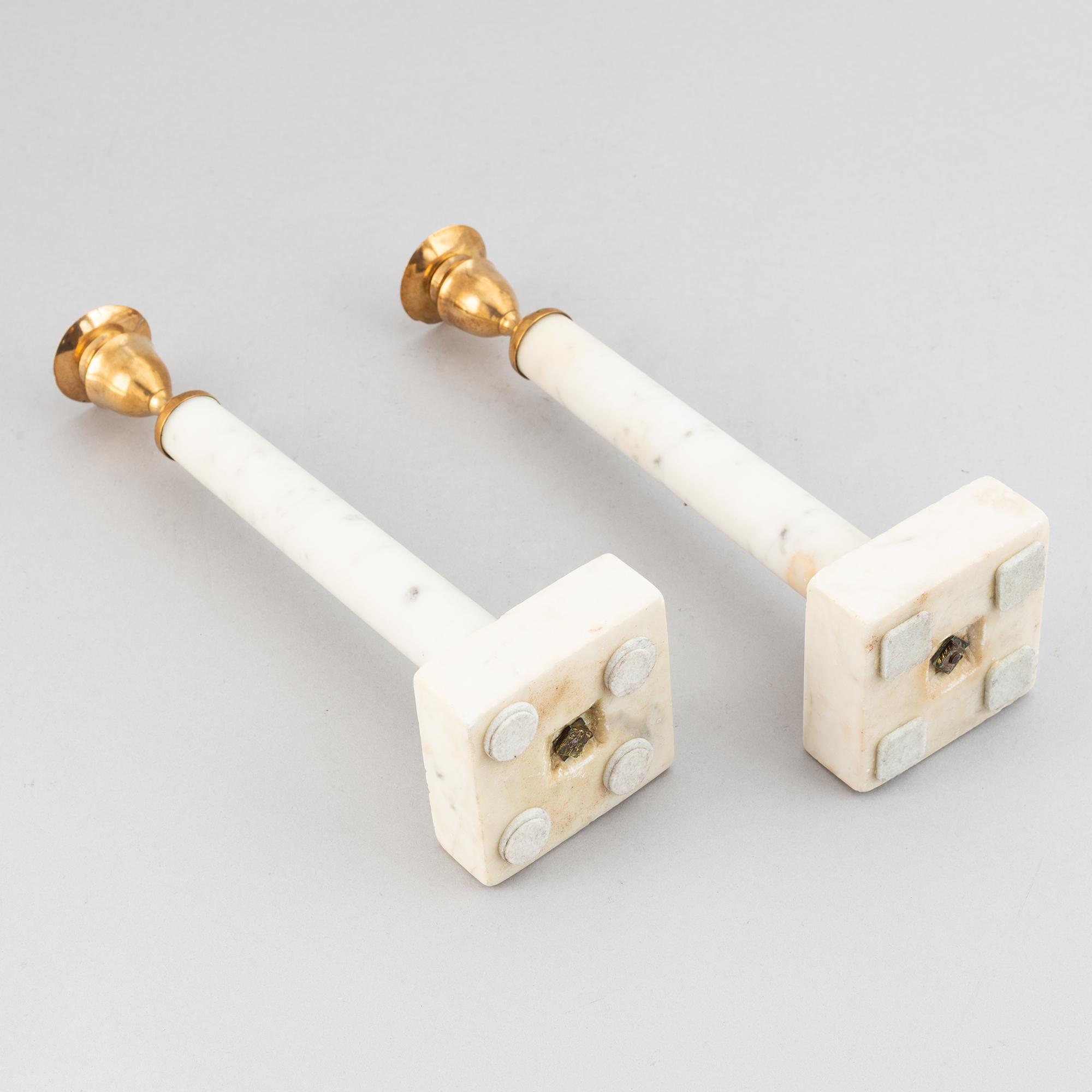 A pair of late Gustavian brass and cararra marble candle holders, around the year 1800.