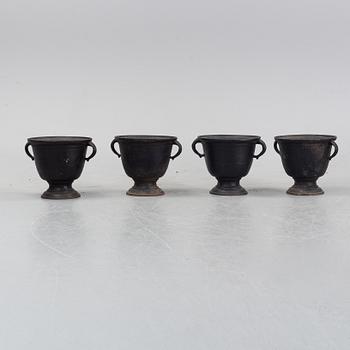 A set of four cast iron garden urns, 20th century.