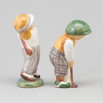 LISA LARSON, a pair of golfer stoneware figurines from Gustavsberg.