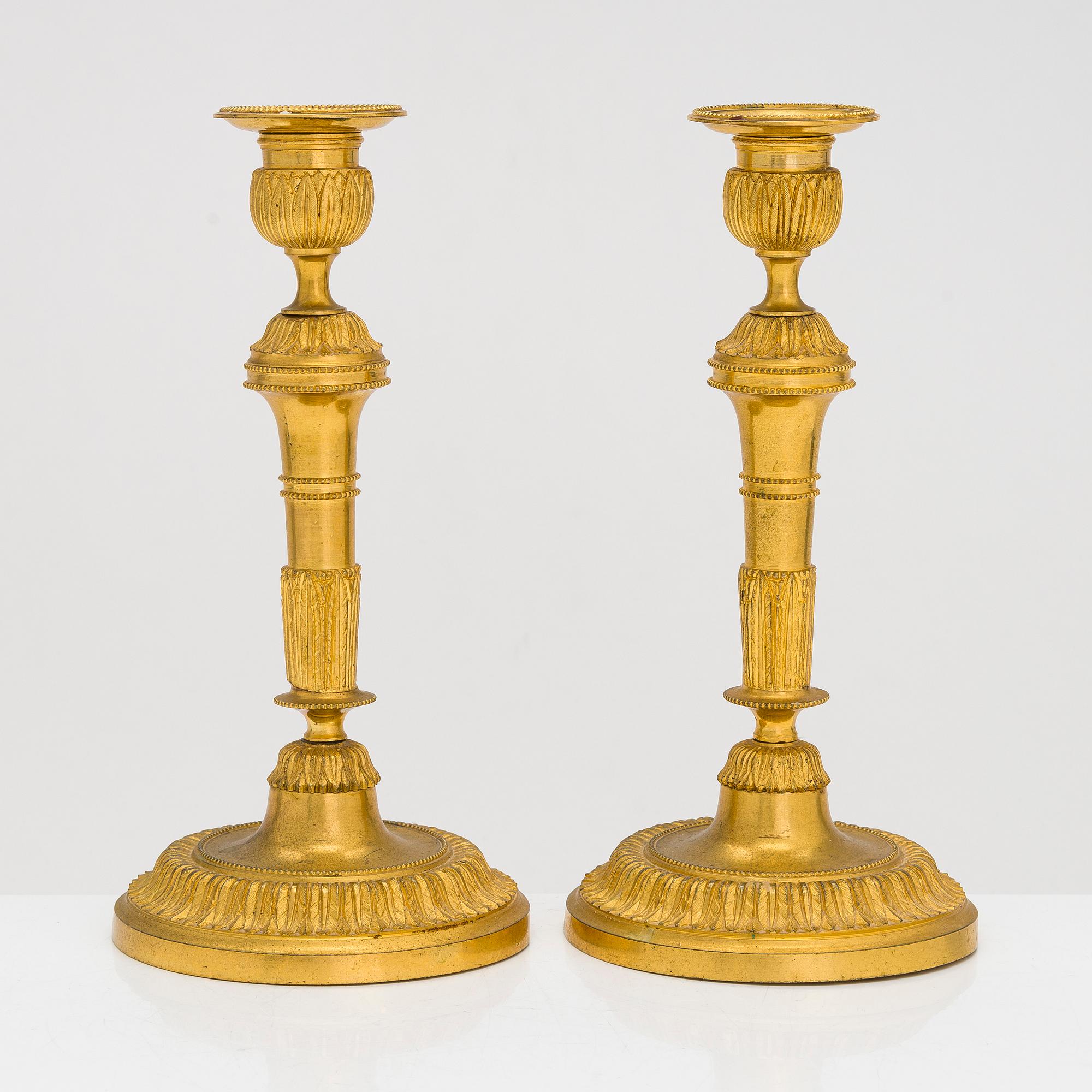 A pair of mid-19th-century gilded bronze candlesticks.