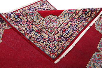 An old Kerman carpet, signed, c. 290 x 208 cm.